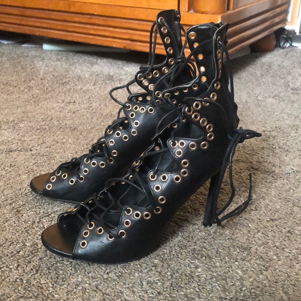 Black and gold tie up heals.